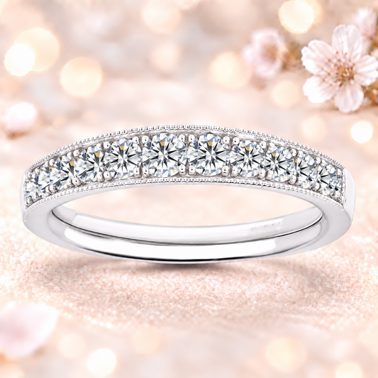 A radiant 1.00 carat Moissanite half-eternity wedding band with delicate milgrain edges, crafted in white-gold-plated 925 silver for timeless sparkle and charm.