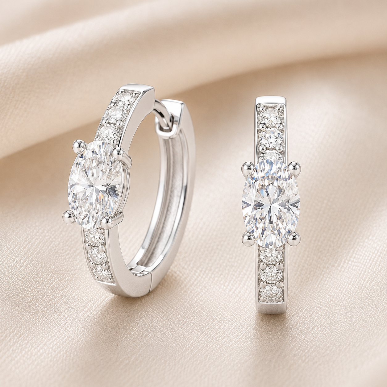 Elegant huggie earrings in white gold-plated 925 silver with a 6×4mm oval-cut Moissanite for timeless brilliance and refined sparkle. Available at BSI Jewelry.