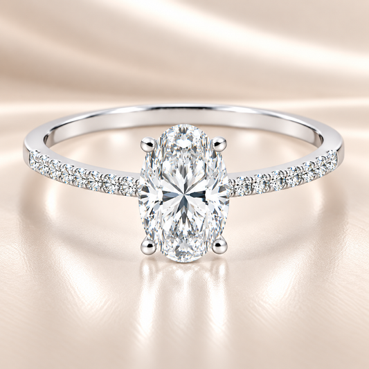 Moissanite oval ring with a 7×5 mm oval-cut stone, accented by moissanite in white gold-plated 925 silver. Elegant and timeless. Available now at BSI Jewelry.