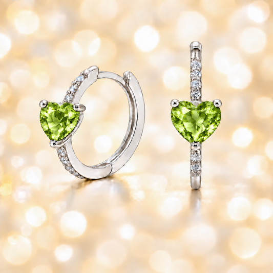 Heart-cut Peridot huggie earrings in white-gold-plated 925 silver with sparkling Moissanite accents for vibrant green brilliance. Available now at BSI Jewelry.