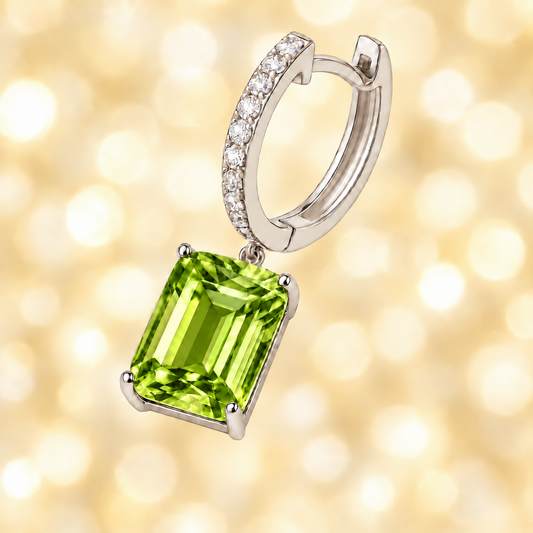 Moissanite & Peridot Huggie Earrings, 8×6 mm emerald cut, crafted in white gold-plated 925 silver. Graceful and hypoallergenic. Available now at BSI Jewelry.