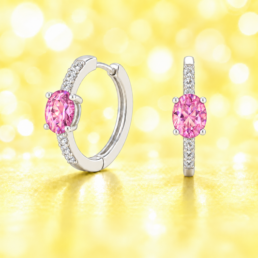 Elegant oval-cut pink amethyst huggie earrings in white gold-plated 925 silver with sparkling Moissanite accents for soft, rosy charm. Available at BSI Jewelry.