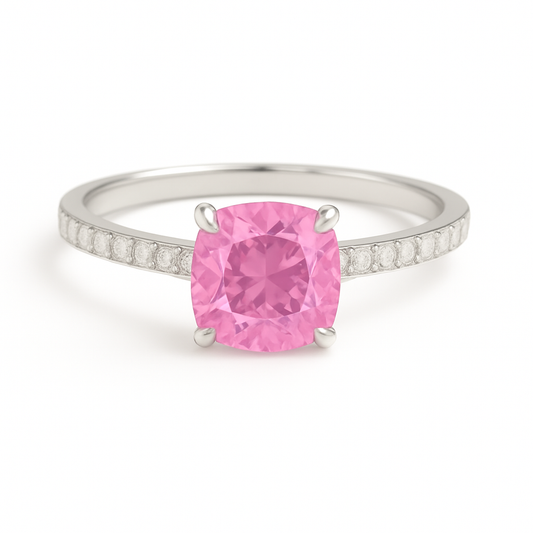 Elegant 7 mm cushion pink sapphire ring accented with Moissanite, crafted in white gold-plated 925 silver with palladium alloy. Available now at BSI Jewelry.
