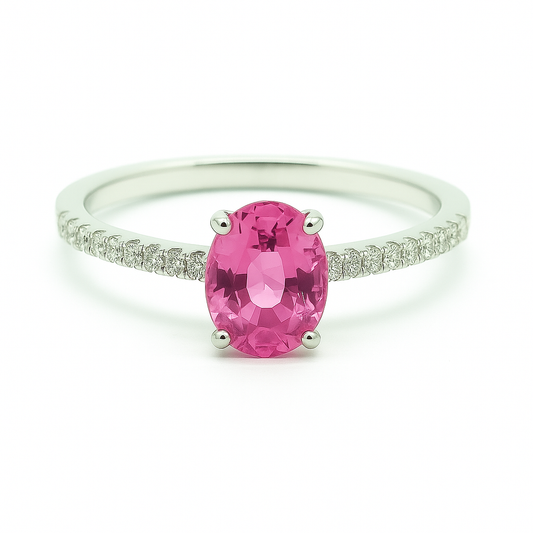 Radiant 7×5 mm pink sapphire oval engagement ring accented with Moissanite, in white gold-plated 925 silver and palladium alloy. Available now at BSI Jewelry.