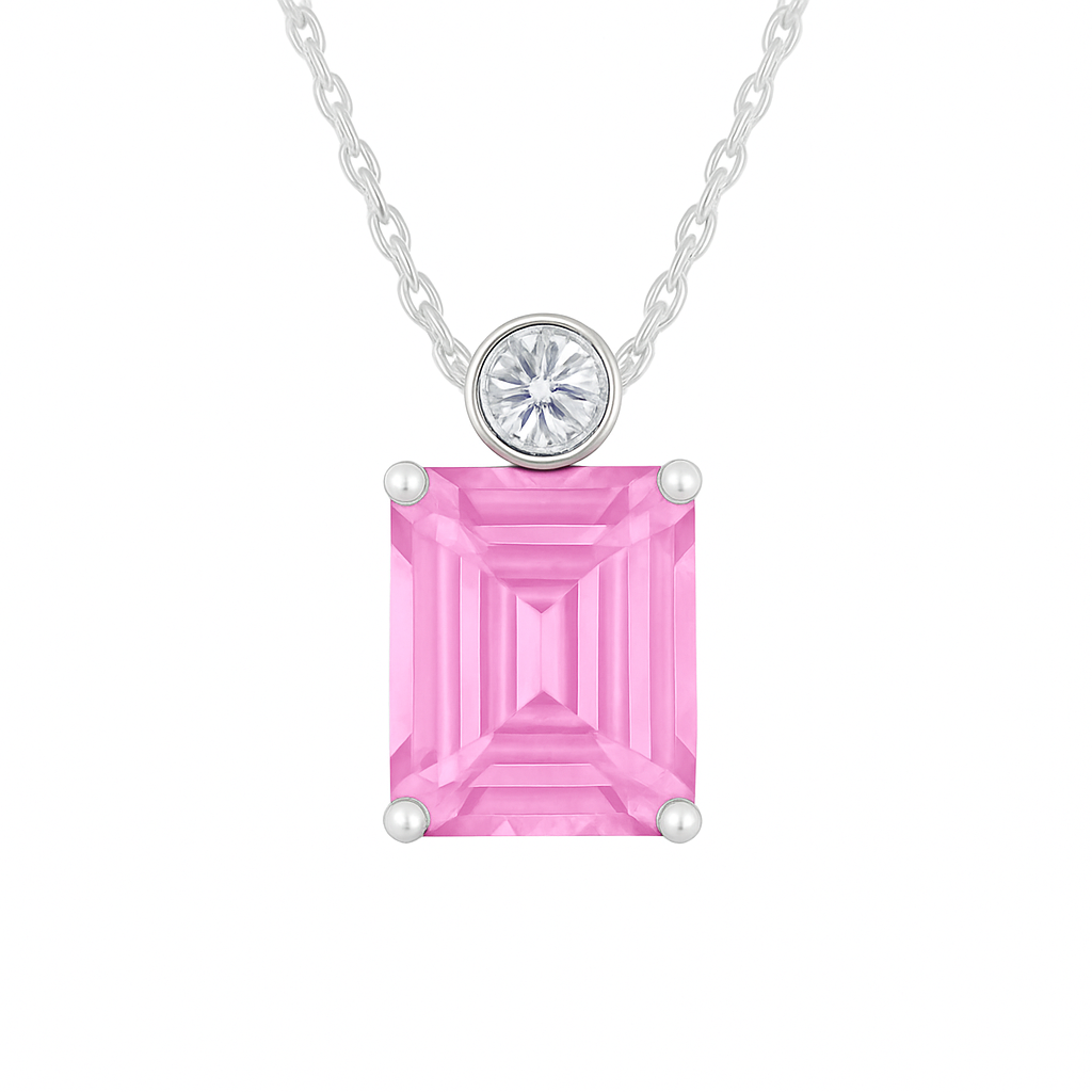 Pink sapphire & Moissanite pendant with 7×5 mm emerald-cut stone in white gold-plated 925 silver. Elegant sparkle and hypoallergenic. Available at BSI Jewelry.