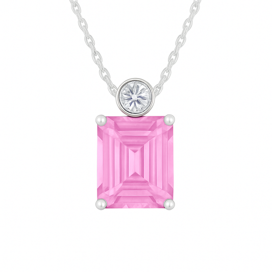 Pink sapphire & Moissanite pendant with 7×5 mm emerald-cut stone in white gold-plated 925 silver. Elegant sparkle and hypoallergenic. Available at BSI Jewelry.