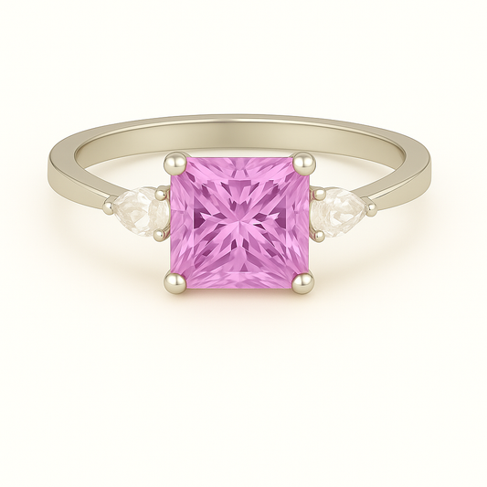 6 mm princess-cut pink sapphire ring with Moissanite accents in white-gold-plated 925 silver. Radiant sparkle and timeless elegance. Available at BSI Jewelry.