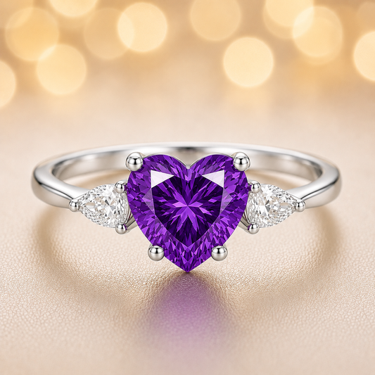 6 mm heart-cut purple sapphire ring with pear-shaped Moissanite accents, set in white-gold-plated 925 silver. Romantic and charming. Available now at BSI Jewelry.