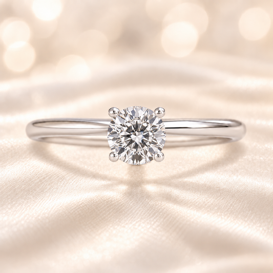 0.10 carat round moissanite solitaire ring in white gold-plated 925 silver. Brilliant sparkle and refined elegance for any occasion. Available now at BSI Jewelry.