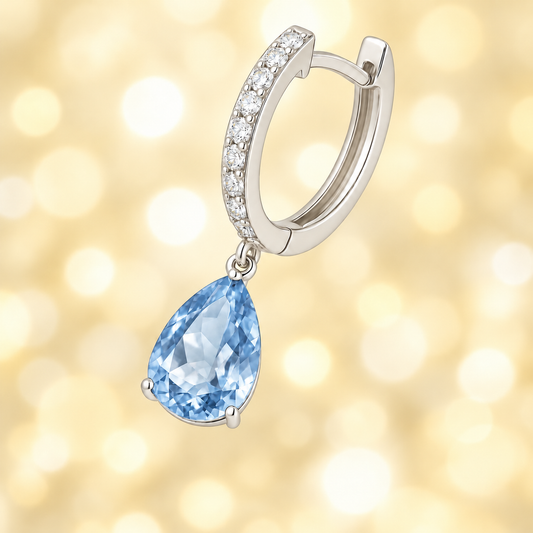 Moissanite & Sky Blue Topaz Huggie Earrings, 8×5 mm pear cut, crafted in white gold-plated 925 silver. Elegant and hypoallergenic. Available now at BSI Jewelry.