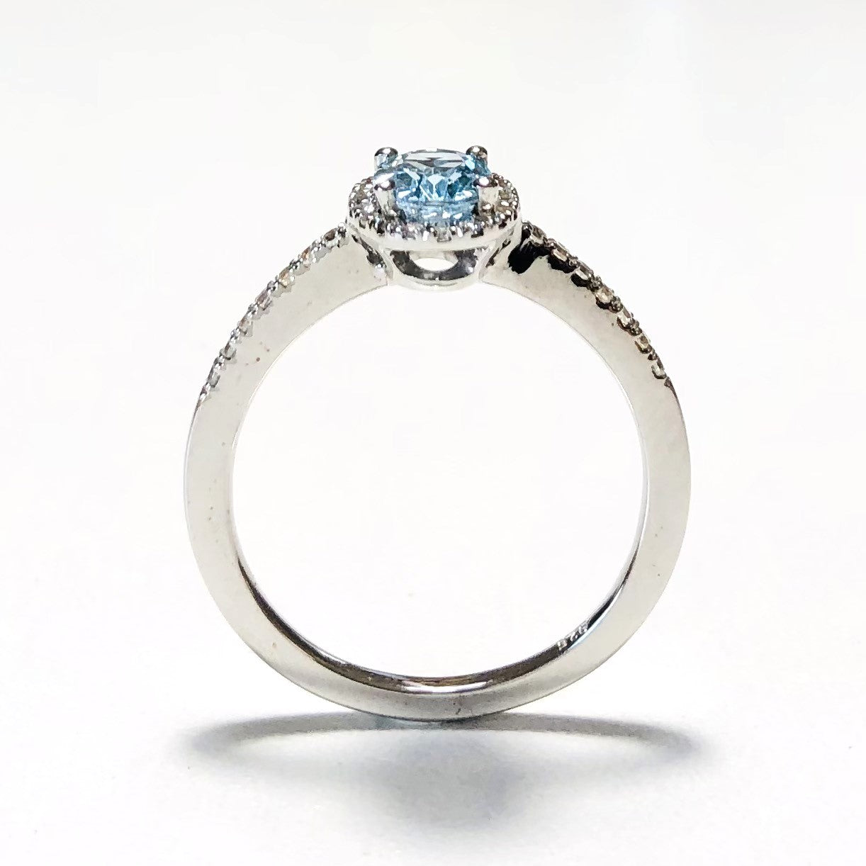 Elegant sky blue topaz halo ring in white gold-plated 925 silver, accented with Moissanite for radiant brilliance. Hypoallergenic. Available now at BSI Jewelry.