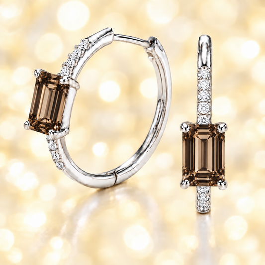 Elegant smoky quartz and Moissanite huggie earrings with 6×4 mm emerald-cut stones in white gold-plated 925 silver. Hypoallergenic comfort. Now at BSI Jewelry.