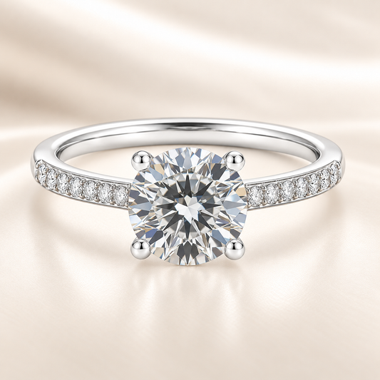 1.00 carat Moissanite solitaire engagement ring with pave-set band in white-gold-plated 925 silver. Elegant and timeless charm. Available now at BSI Jewelry.