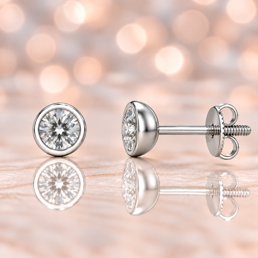 Moissanite stud earrings with 4.8 mm round stones in sleek bezel setting, crafted in white gold-plated 925 silver. Modern and elegant. Available at BSI Jewelry.
