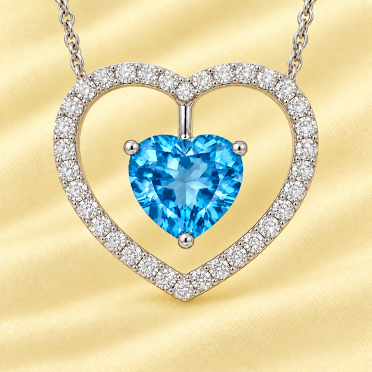 Moissanite and Swiss blue topaz necklace with a 6 mm heart-cut gemstone in white gold-plated 925 silver. Fresh and elegant. Available now at BSI Jewelry.