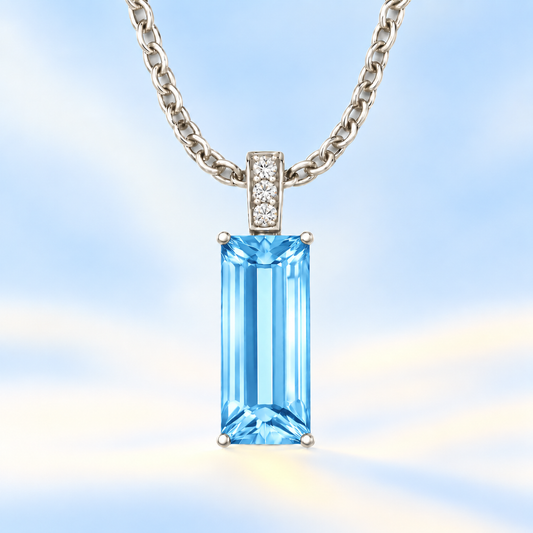 Moissanite and Swiss blue topaz pendant with a 14 × 6 mm baguette-cut gemstone in white gold-plated 925 silver. Fresh and elegant. Available now at BSI Jewelry.