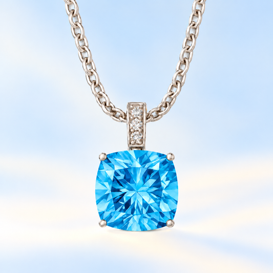 Moissanite and Swiss blue topaz pendant with a 6 mm cushion-cut gemstone in white gold-plated 925 silver. Fresh and elegant. Available now at BSI Jewelry.
