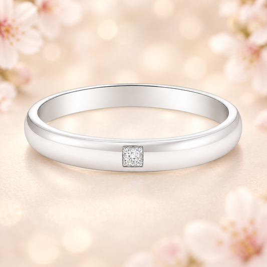 Elegant 2.5 mm Moissanite wedding band with a single round brilliant, crafted in white gold-plated 925 silver and palladium alloy. Available now at BSI Jewelry.
