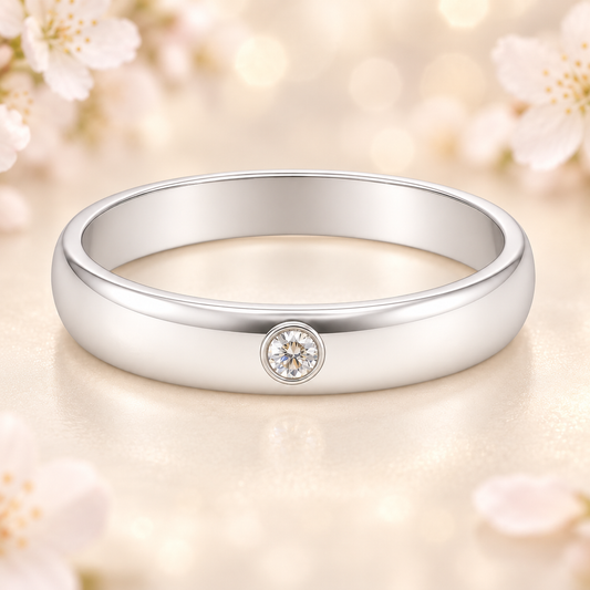 Sleek Moissanite wedding band with a single round brilliant in 3.50 mm width. White gold-plated 925 silver with palladium alloy. Available now at BSI Jewelry.