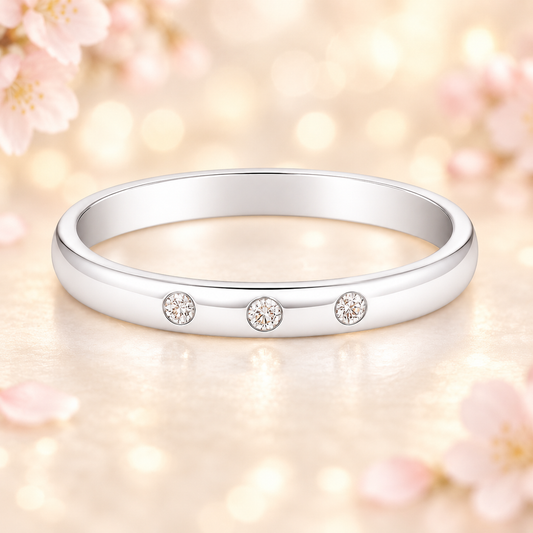 Moissanite wedding band with three round stones in 3.50 mm width. White-gold-plated 925 silver, hypoallergenic and elegant. Available now at BSI Jewelry.