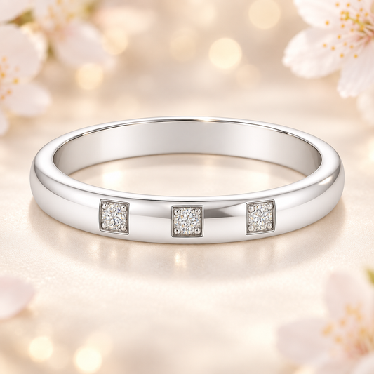 Elegant three-stone Moissanite wedding band with 2.50 mm width, crafted in white gold-plated 925 silver with palladium alloy. Available now at BSI Jewelry.