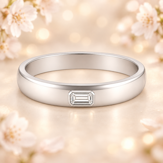 Moissanite wedding band featuring 4×2 mm emerald-cut stones in white gold-plated 925 silver and palladium alloy. Radiant and refined. Available at BSI Jewelry.