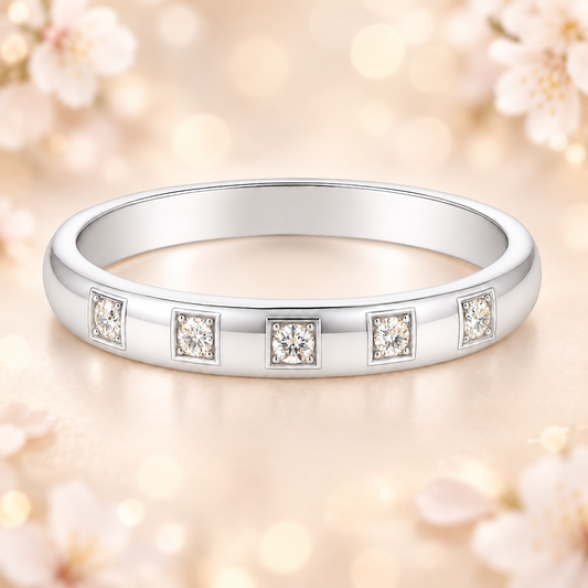 Elegant 2.5 mm Moissanite wedding band with five round brilliant, crafted in white gold-plated 925 silver and palladium alloy. Available now at BSI Jewelry.