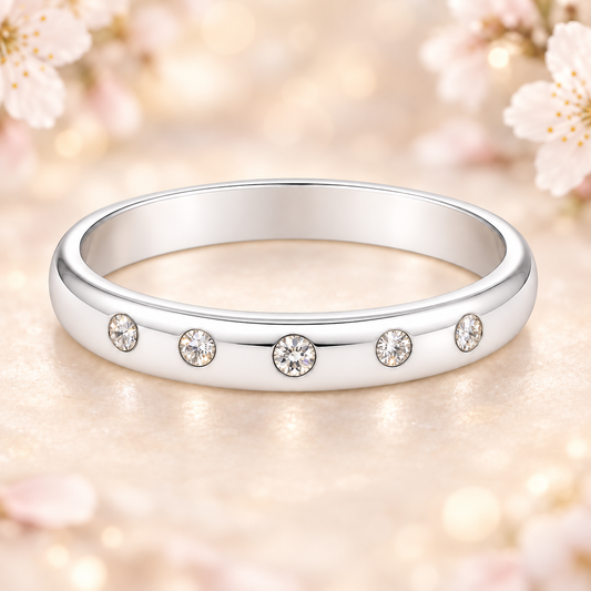 Timeless Moissanite wedding band with five round brilliant stones in 2.50 mm width. White gold-plated 925 silver with palladium alloy. Now at BSI Jewelry.