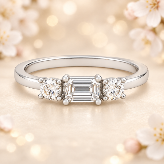 Moissanite wedding band with 5×3 mm emerald-cut and 3 mm round in white gold-plated 925 silver with palladium alloy. Elegant and radiant. Now at BSI Jewelry.