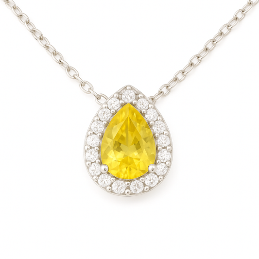 Radiant 7×5mm yellow sapphire halo necklace accented with Moissanite, crafted in white gold-plated 925 silver and palladium alloy. Available now at BSI Jewelry.