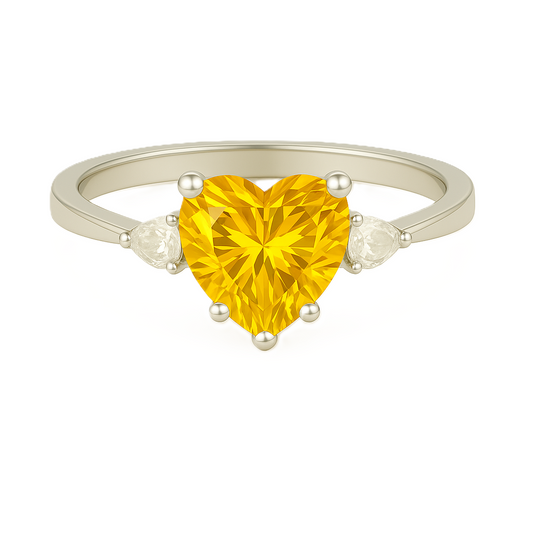 6 mm heart-cut yellow sapphire ring with pear-shaped Moissanite accents, set in white-gold-plated 925 silver. Romantic and charming. Available at BSI Jewelry.