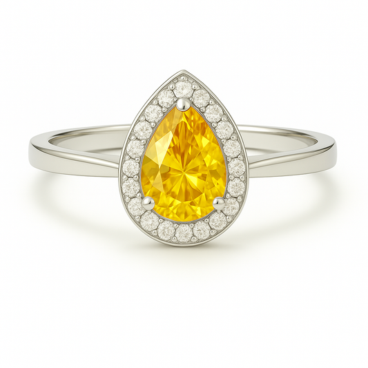 7×5 mm pear-cut yellow sapphire ring with Moissanite halo, crafted in white-gold-plated 925 silver. Elegant sparkle and timeless charm. Available at BSI Jewelry.
