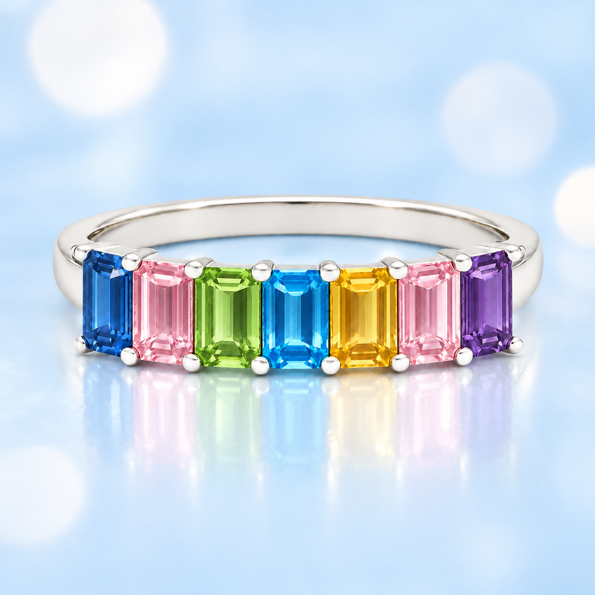 Multi-color gemstone ring with seven 5×3 mm emerald-cut stones in white gold-plated 925 silver, creating a refined rainbow look. Shop BSI Jewelry.