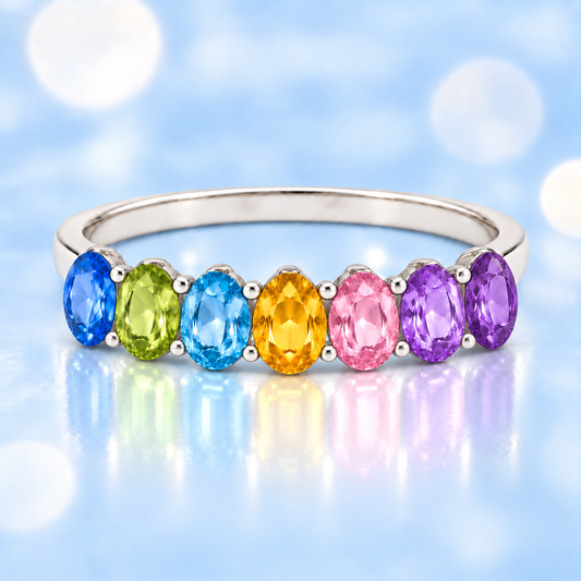 Multi-color gemstone ring with seven 5×3 mm oval-cut stones in white gold-plated 925 silver, creating a refined rainbow look. Shop BSI Jewelry.