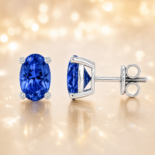Oval blue sapphire stud earrings with 6×4 mm oval stones and moissanite prongs in white gold plated 925 silver. Available now at BSI Jewelry.