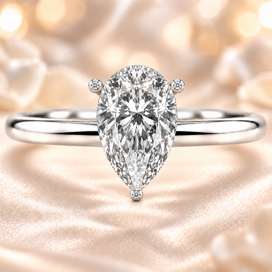 Timeless pear moissanite engagement ring with a 6×4 mm pear-cut center stone, crafted in white gold plated 925 silver. Available now at BSI Jewelry.