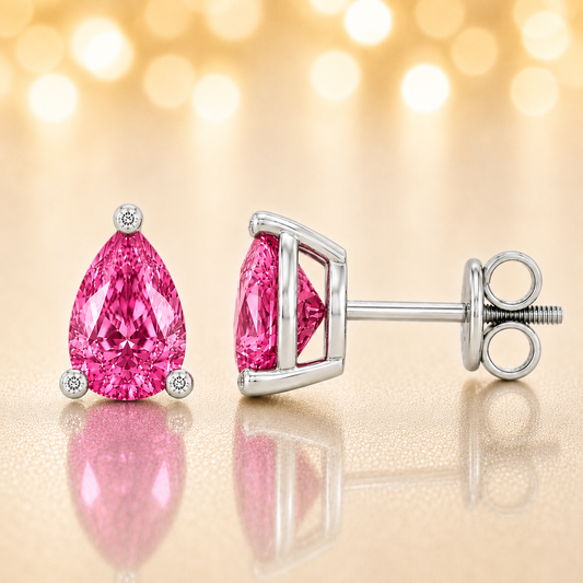 Pear pink sapphire stud earrings with 6×4 mm stones and moissanite prongs in white gold plated 925 silver. Available now at BSI Jewelry.