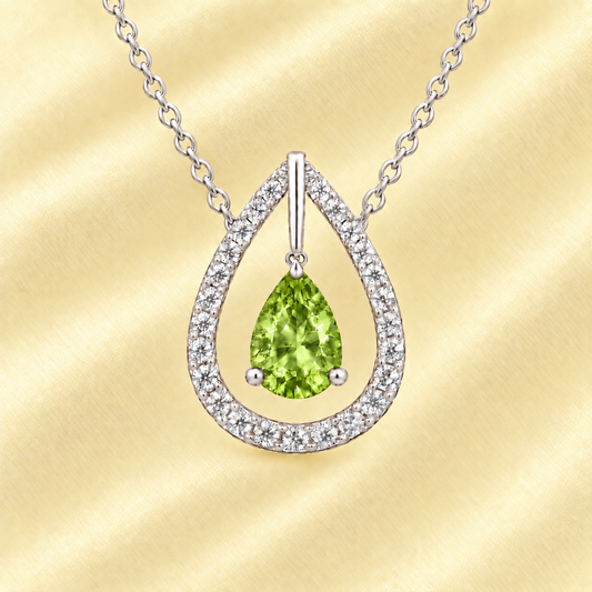 Peridot necklace with a 7×5 mm pear-cut in white gold-plated 925 silver, accented by a moissanite halo. Elegant and refined. Available now at BSI Jewelry.