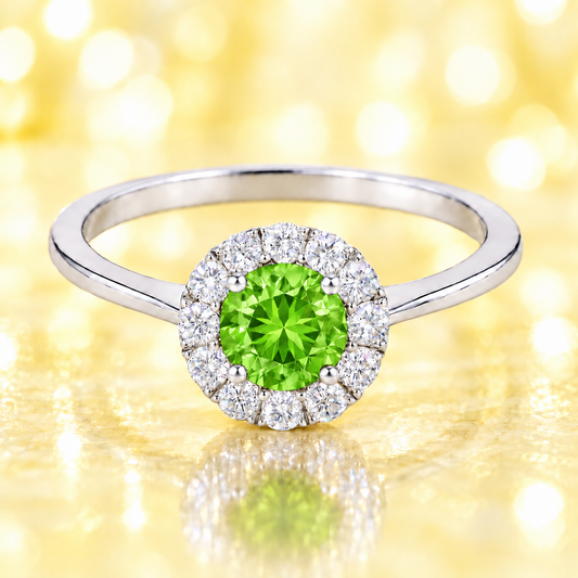 Peridot ring with a 4.50 mm round-cut stone in white gold-plated 925 silver, accented with moissanite for fresh green brilliance. Available now at BSI Jewelry.