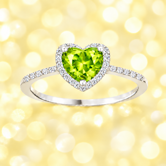 Peridot ring with a 6 mm heart cut, crafted in white gold-plated 925 silver and accented with moissanite. Available now at BSI Jewelry.