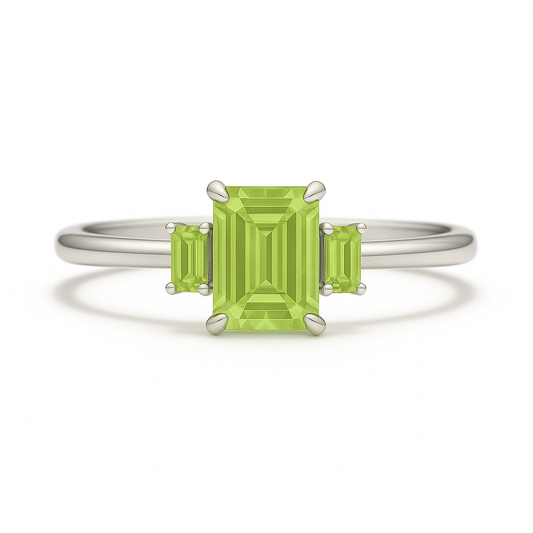 Elegant peridot ring with 6×4 mm and 4×2 mm emerald-cut stones in white gold-plated 925 silver with palladium alloy. Fresh brilliance. Available at BSI Jewelry.