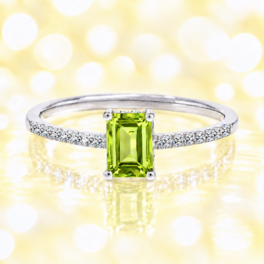 Peridot ring with a 7×5 mm emerald cut in white gold-plated 925 silver, with moissanite. Elegant and refined for daily wear. Available now at BSI Jewelry.