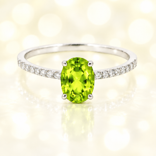 Peridot ring with a 7×5 mm oval-cut stone and moissanite accents in white gold plated 925 silver. Elegant for daily wear. Available now at BSI Jewelry.