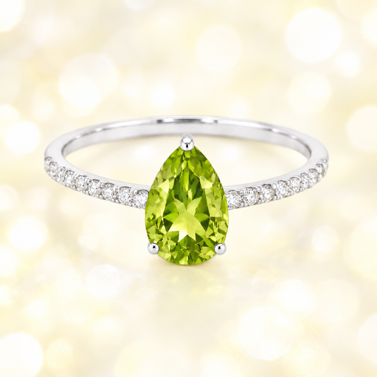 Peridot ring with a 7×5 mm pear-cut stone and moissanite accents in white gold plated 925 silver. Elegant for daily wear. Available now at BSI Jewelry.