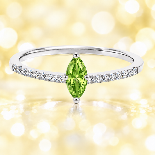 Peridot ring with an 8×4 mm marquise-cut stone, accented by moissanite in white gold-plated 925 silver. Fresh and elegant. Available now at BSI Jewelry.
