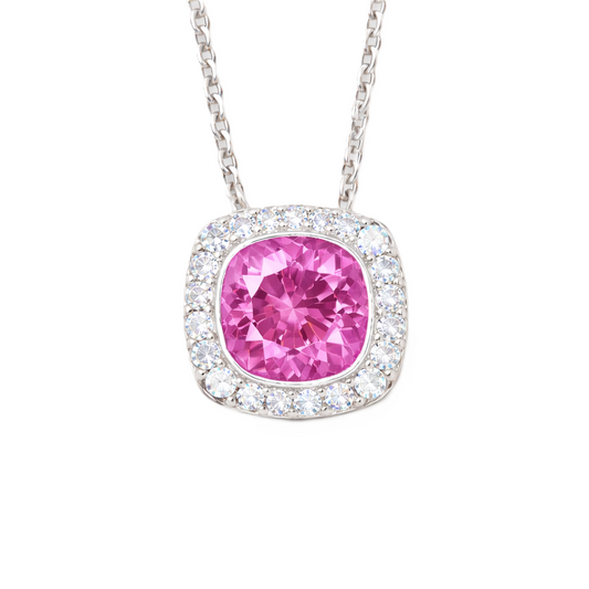Pink sapphire cushion pendant with 6 mm center stone in white gold-plated 925 silver, accented with moissanite. Elegant and romantic. Available now at BSI Jewelry.