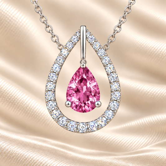 Pink sapphire necklace with a 7×5 mm pear cut and moissanite halo, crafted in white gold-plated 925 silver. Elegant and refined. Available now at BSI Jewelry.