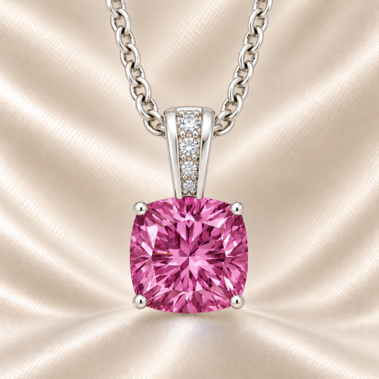 Pink sapphire pendant with a 6 mm cushion gemstone in white gold-plated 925 silver, accented with moissanite. Elegant and refined. Available now at BSI Jewelry.