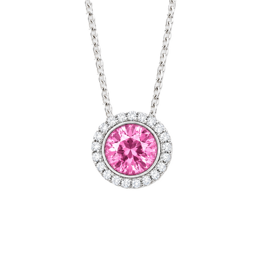 Pink sapphire pendant with 6 mm round stone in white gold-plated 925 silver, accented with moissanite and adjustable cable chain. Available now at BSI Jewelry.