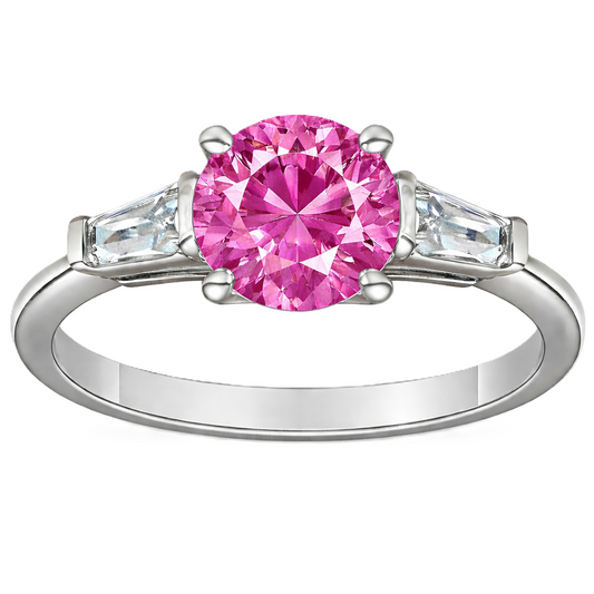 Pink sapphire ring, 6 mm round, with tapered moissanite accents in white gold-plated 925 silver. Soft and radiant. Available now at BSI Jewelry.